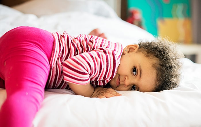 Child laying in new bed